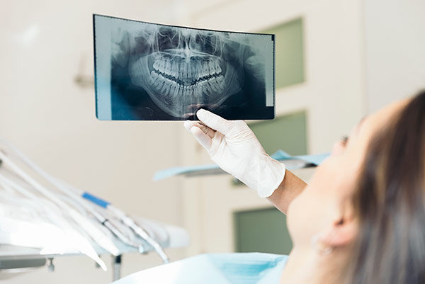 A dentist showing a patient their dental x-ray.