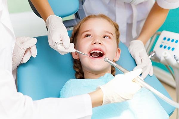 A girl with signs of a cavity visiting the dentist for examination.