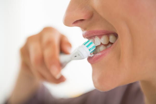 A person keeping their teeth healthy by brushing