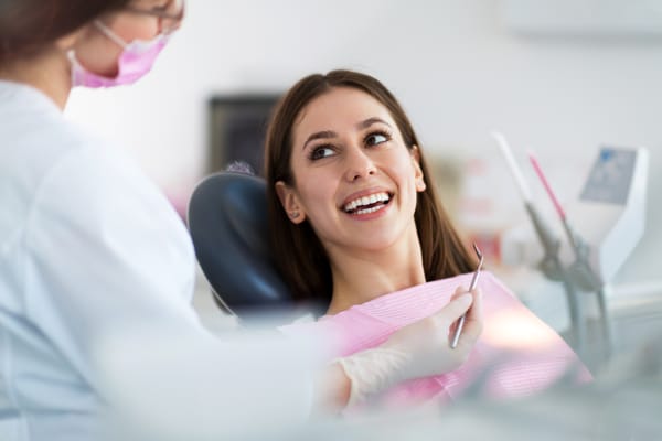 A woman sitting in a dental chair for her routine dental checkup